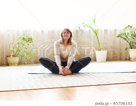 Adult woman doing yoga at home 65706102