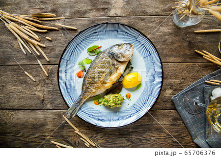 Top view appetizing gourmet grilled roasted fish Top view appetizing gourmet grilled roasted fish 65706376