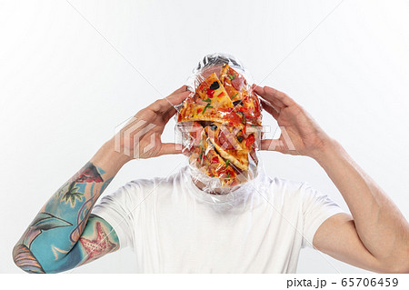 Male face covered with oilcloth, cellophane and unhealthy food, hard to breathe. People lost their faces, can't notice the environmental pollution made by themself. 65706459