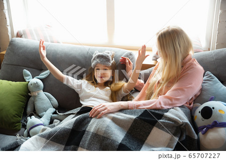 Mother and daughter, sisters have quite, beauty and fun day together at home. Comfort and togetherness. Waking up in bedroom, good morning. 65707227