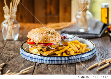 Closeup on cheeseburger with fries Closeup on cheeseburger with fries 65707342