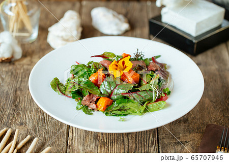 Side view on gourmet salmon and beef meat salad Side view on gourmet salmon and beef meat salad 65707946