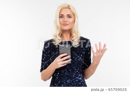 pensive lady in a shiny dress surfing the Internet from the phone on a white background with copy pensive lady in a shiny dress surfing the Internet from the phone on a white background with copy 65709020