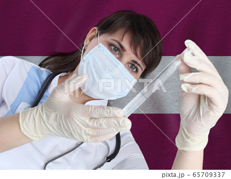 Scientist woman with test tube Coronavirus  65709337