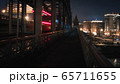 pedestrian railway bridge and the lights of a passing train at night 65711655