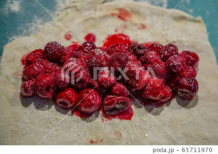 Dough with flour for making cherry pie Dough with flour for making cherry pie 65711970