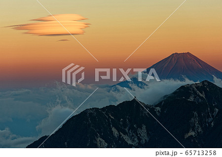 甲斐駒ヶ岳から見る夕焼けの富士山 鳳凰山と吊るし雲の写真素材