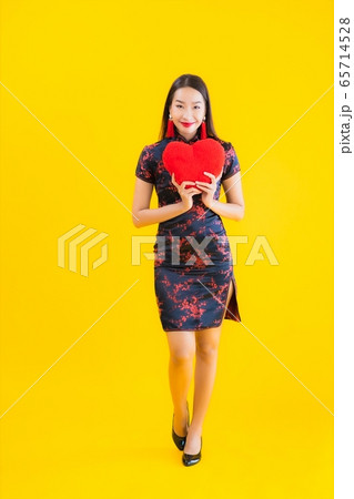 Portrait beautiful young asian woman wear chinese dress show heart shape pillow Portrait beautiful young asian woman wear chinese dress show heart shape pillow 65714528