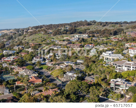 Aerial view of La Jolla little coastline city with wealthy villas and swimming pool.  65717057