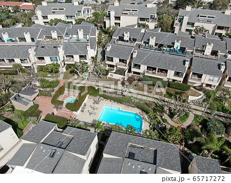 Aerial view of condo community with tennis court and pool in South California 65717272