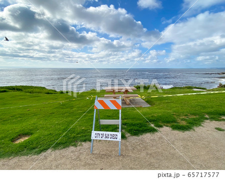 Closed La Jolla Beach with informative signage during COVID-19 pandemic.  65717577