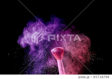 A brush with pink and purple make up powder impact to make a colorful cloud. A brush with pink and purple make up powder impact to make a colorful cloud. 65718798