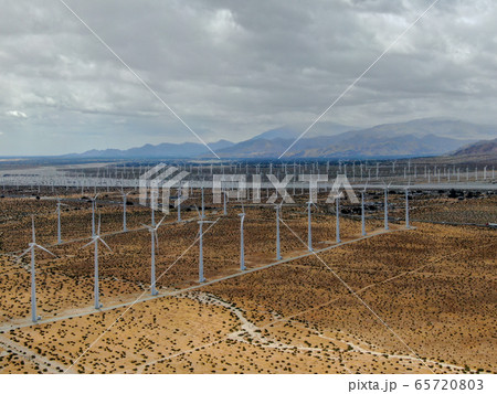 Aerial view of huge array of gigantic wind turbines spreading over the desert in Palm Springs. Aerial view of huge array of gigantic wind turbines spreading over the desert in Palm Springs. 65720803
