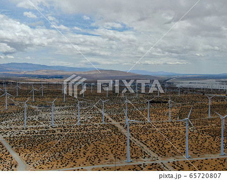 Aerial view of huge array of gigantic wind turbines spreading over the desert in Palm Springs. Aerial view of huge array of gigantic wind turbines spreading over the desert in Palm Springs. 65720807