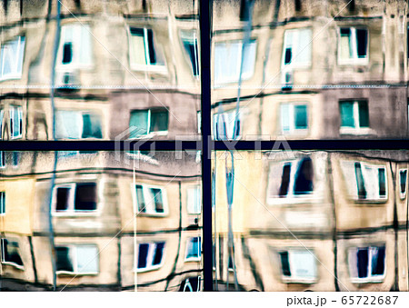 crooked reflection of houses in a glass window crooked reflection of houses in a glass window 65722687