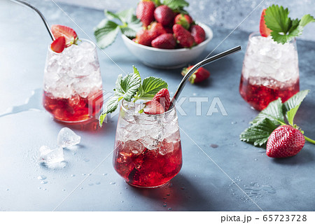 Red cocktail with ice and fresh strawberry 65723728