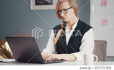 Mature businesswoman working on laptop Mature businesswoman working on laptop 65725369