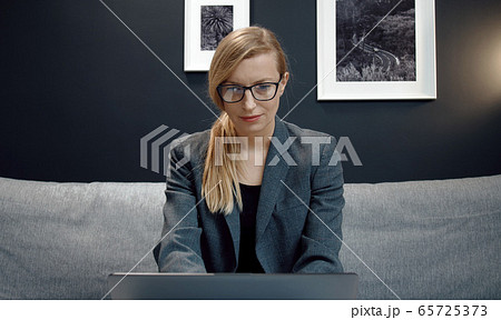 Businesswoman looking computer screen Businesswoman looking computer screen 65725373