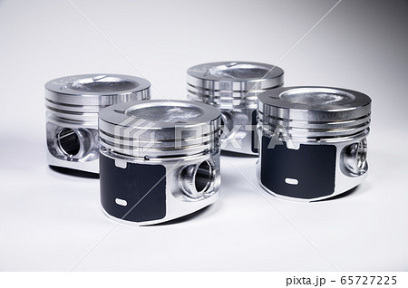 Close-up of four new internal combustion engine piston on a gray gradient background. The concept of new spare parts of the internal combustion engine Close-up of four new internal combustion engine piston on a gray gradient background. The concept of new spare parts of the internal combustion engine 65727225