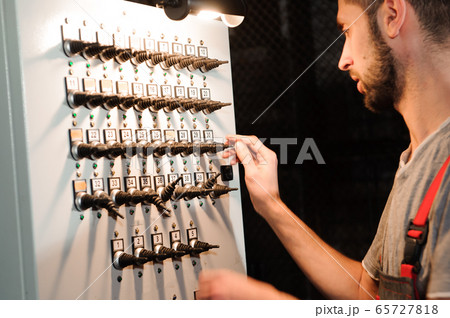 The lighting engineer adjusts the lights on stage behind the scenes 65727818