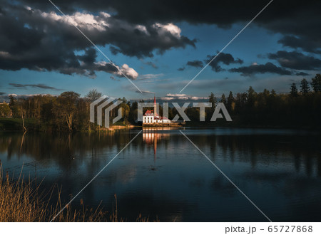 dramatic landscape with a castle and dark clouds. 65727868
