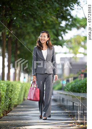 Businesswoman walking outdoors Businesswoman walking outdoors 65728083