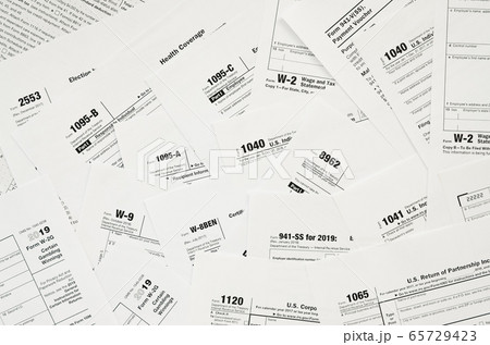 Many tax form blanks lies on table close up. Tax Many tax form blanks lies on table close up. Tax 65729423