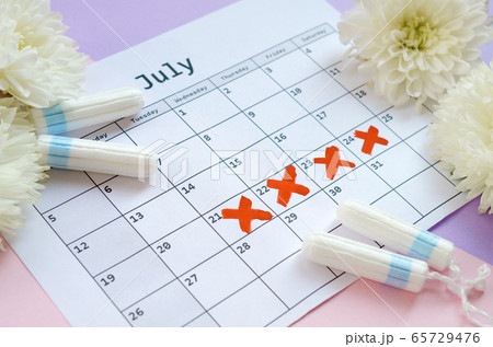 Menstrual tampons on menstruation period calendar 65729476