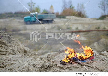 Burning sports sneakers or gym shoes on fire stand 65729556