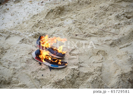 Burning sports sneakers or gym shoes on fire stand Burning sports sneakers or gym shoes on fire stand 65729581