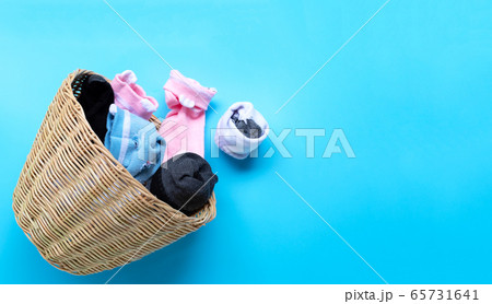 Laundry basket with socks on blue background. Laundry basket with socks on blue background. 65731641