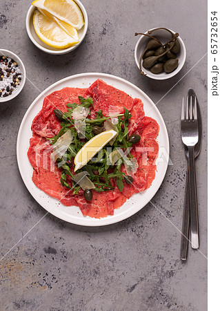 Marbled beef carpaccio with arugula, capers, lemon 65732654