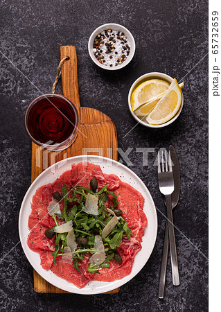 Marbled beef carpaccio with arugula, capers and Marbled beef carpaccio with arugula, capers and 65732659