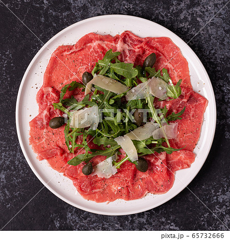 Marbled beef carpaccio with arugula, capers and 65732666