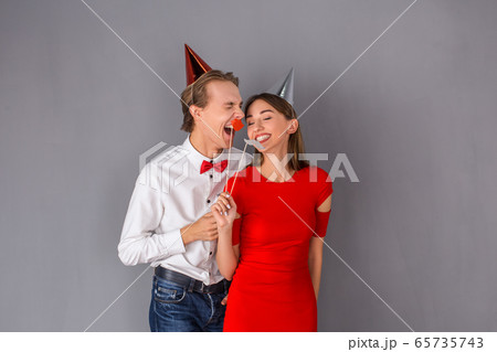 Young couple studio isolated on grey wall concept Young couple studio isolated on grey wall concept 65735743