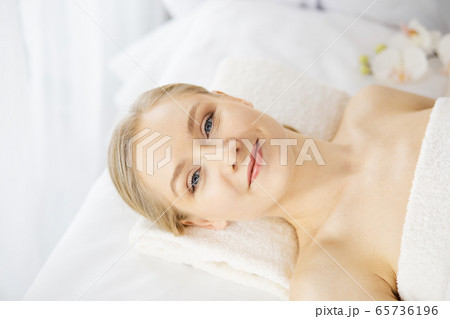 Happy beautiful woman smiles before spa procedures getting. Beauty and joy concept 65736196