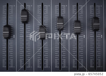 Audio mixer with foreground faders ready for recording and equalizing in an audio production Audio mixer with foreground faders ready for recording and equalizing in an audio production 65745052
