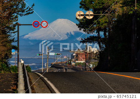 日本の観光名所、稲村ガ崎の爽やかな青空の下にそびえる雄大な富士山に向かう国道134号線 65745121