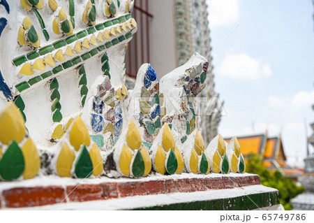 Wat Arun temple in Bangkok Thailand. Wat Arun-Buddhist temple in Bangkok's Yai district of Bangkok, Thailand, Wat Arun mosaic close-up Wat Arun temple in Bangkok Thailand. Wat Arun-Buddhist temple in Bangkok's Yai district of Bangkok, Thailand, Wat Arun mosaic close-up 65749786