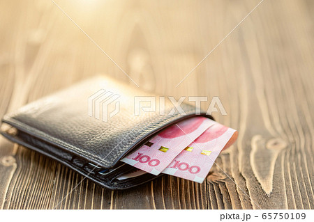 Black leather wallet with Chinese banknote on 65750109