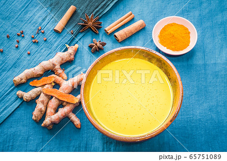 Turmeric milk with ingredients on blue background Turmeric milk with ingredients on blue background 65751089
