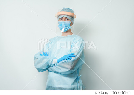 Doctor wearing surgical face mask and gloves. Doctor wearing surgical face mask and gloves. 65756164