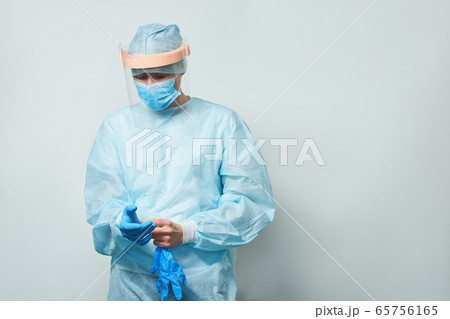 Doctor wearing surgical face mask and gloves. Doctor wearing surgical face mask and gloves. 65756165