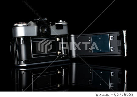 Vintage antique camera isolated on black glass 65756658