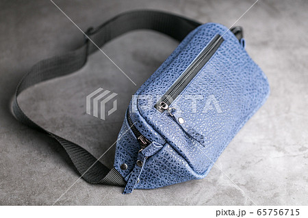 Waist bag made of blue leather, banana on a gray Waist bag made of blue leather, banana on a gray 65756715