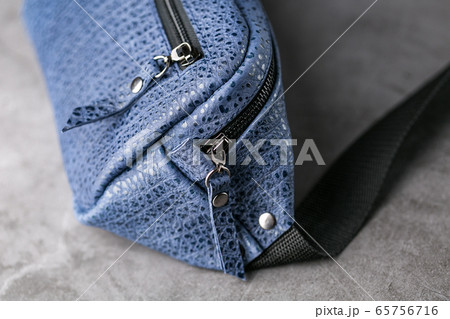 Waist bag made of blue leather, banana on a gray Waist bag made of blue leather, banana on a gray 65756716