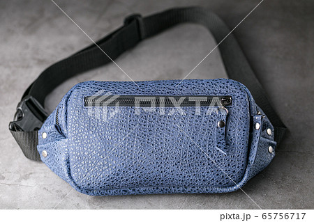 Waist bag made of blue leather, banana on a gray Waist bag made of blue leather, banana on a gray 65756717