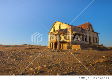 Sunrise above an abandoned house in Kolmanskop ghost town, Namibia Sunrise above an abandoned house in Kolmanskop ghost town, Namibia 65758214