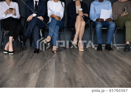 Diverse people sitting in row, candidates waiting for job interview 65760367