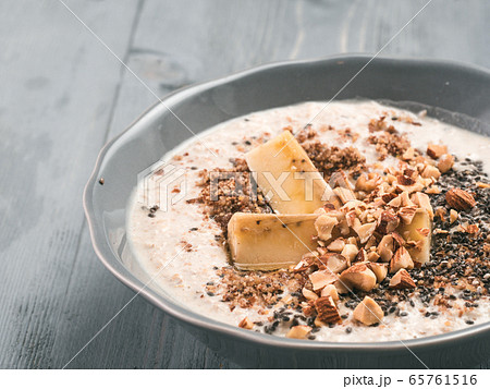 Overnight oats in bowl and ingredients on gray wooden table Overnight oats in bowl and ingredients on gray wooden table 65761516